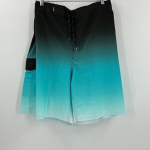 Rokka&Rolla men's 4-way stretch swim trunks featuring a black-to-teal ombre fade